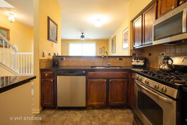 kitchen featuring ceiling fan, sink, stainless steel appliances, backsplash, and light tile patterned floors