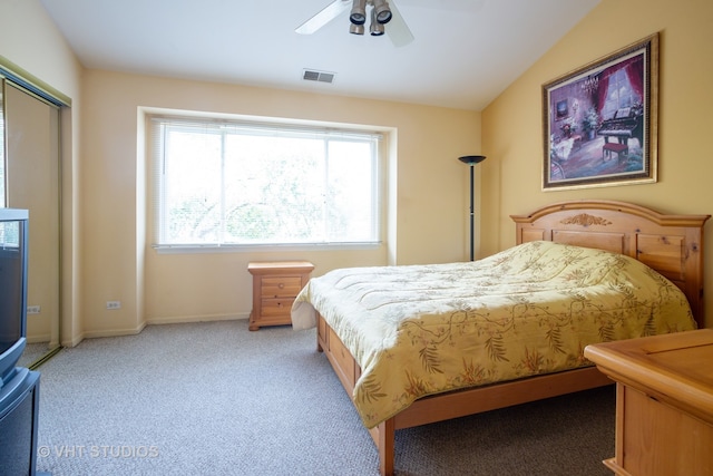 bedroom with light colored carpet, vaulted ceiling, and ceiling fan