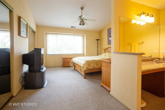 bedroom featuring light colored carpet, ceiling fan, lofted ceiling, and sink