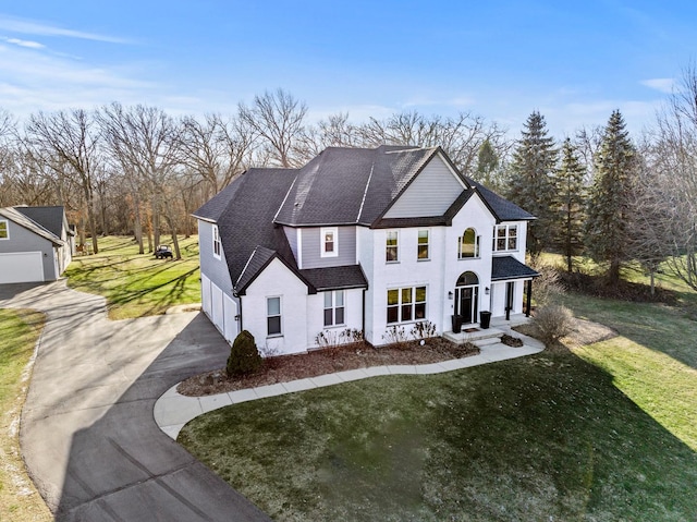 view of front of property with a front yard and a garage