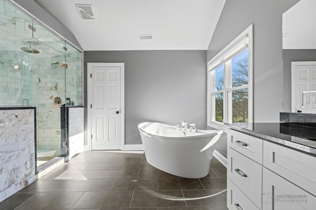 bathroom featuring vanity, tile patterned flooring, plus walk in shower, and lofted ceiling