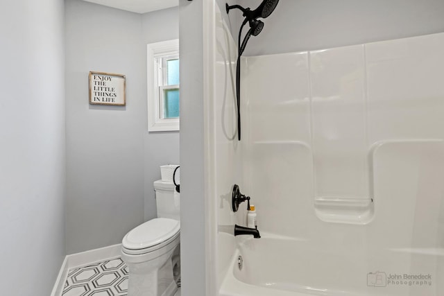 bathroom featuring shower / tub combination and toilet