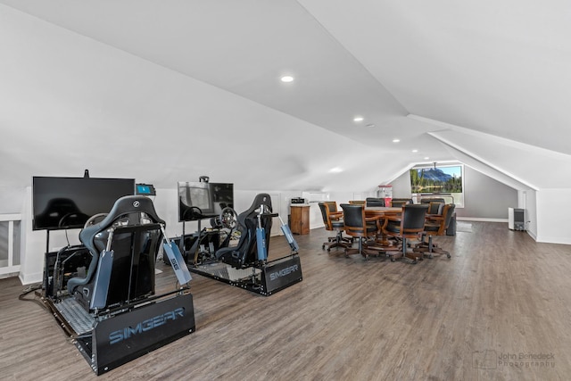 exercise area with vaulted ceiling and hardwood / wood-style flooring