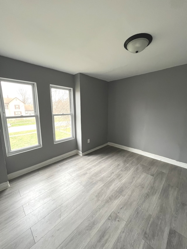 unfurnished room with light hardwood / wood-style floors