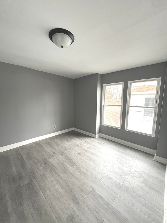 unfurnished room with light hardwood / wood-style floors