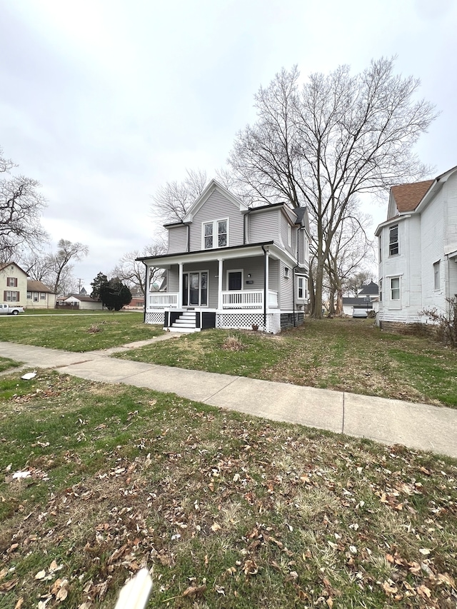 view of front of house with a porch and a front yard