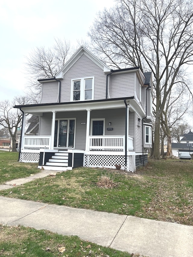 view of front facade with covered porch and a front yard