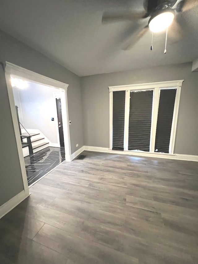 interior space with ceiling fan and dark wood-type flooring