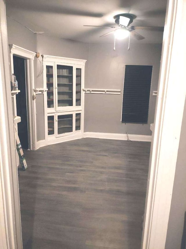 spare room featuring ceiling fan and dark hardwood / wood-style flooring