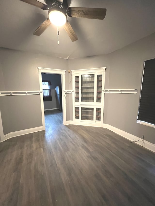 unfurnished room with dark wood-type flooring