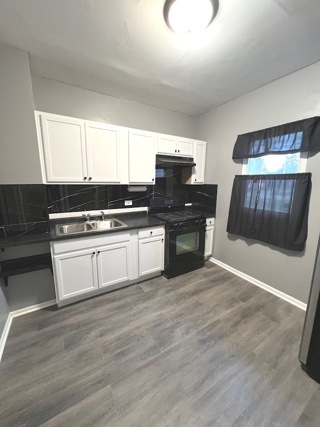 kitchen with white cabinets, backsplash, black range with gas stovetop, and sink