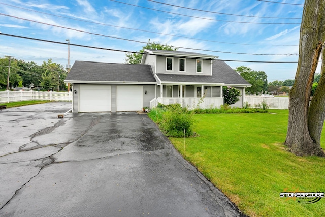 view of property with a porch, a garage, and a front yard