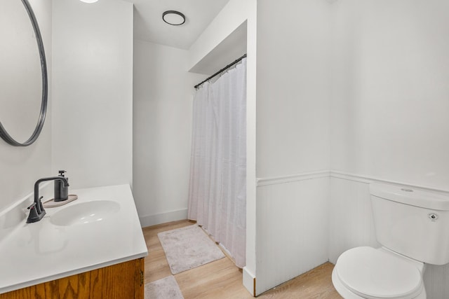 bathroom featuring vanity, hardwood / wood-style floors, and toilet