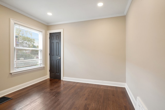 spare room with dark hardwood / wood-style flooring and ornamental molding