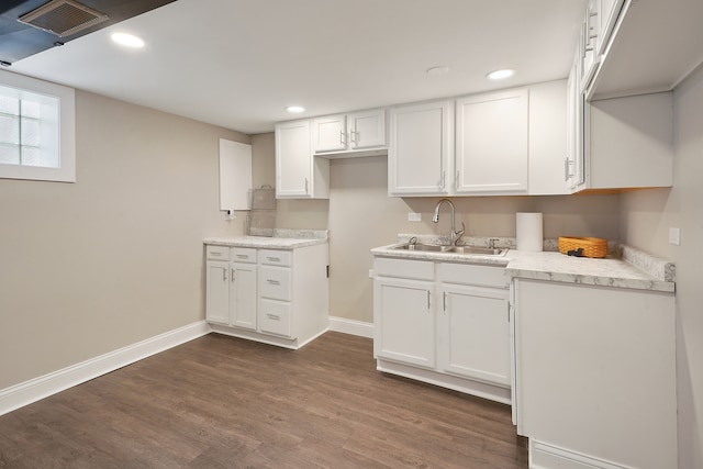 kitchen with white cabinetry, dark wood-type flooring, and sink