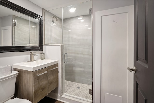 bathroom with vanity, toilet, and an enclosed shower