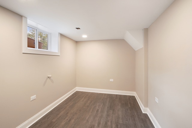 basement with dark hardwood / wood-style floors