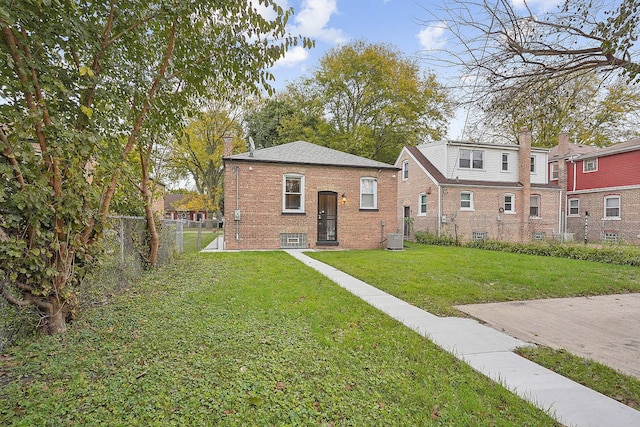 view of front of home featuring a front yard and central AC