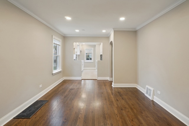 unfurnished room with ornamental molding and dark wood-type flooring