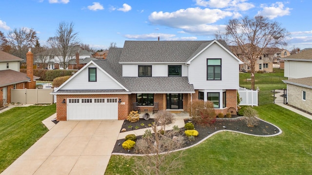 view of front of house featuring a garage and a front lawn