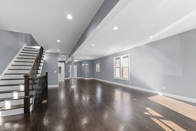 unfurnished living room with dark hardwood / wood-style flooring