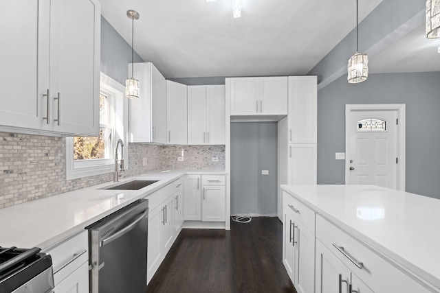 kitchen with white cabinets, sink, appliances with stainless steel finishes, and dark wood-type flooring