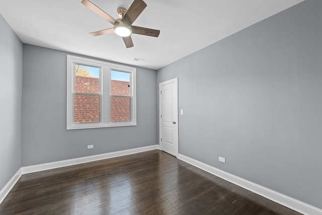 empty room featuring ceiling fan and dark hardwood / wood-style flooring