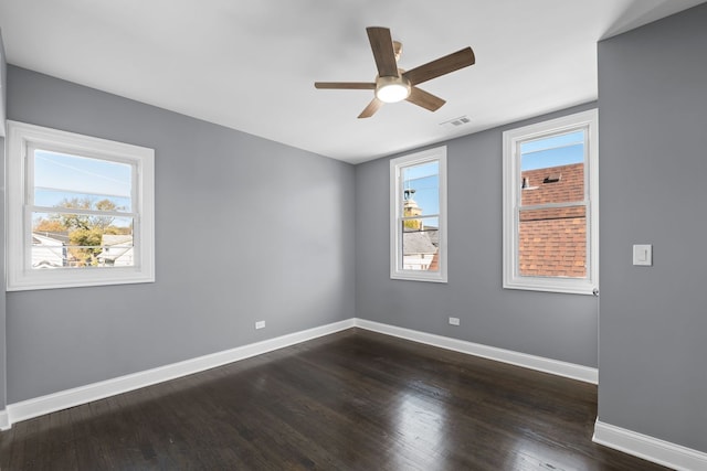 unfurnished room with ceiling fan and dark wood-type flooring