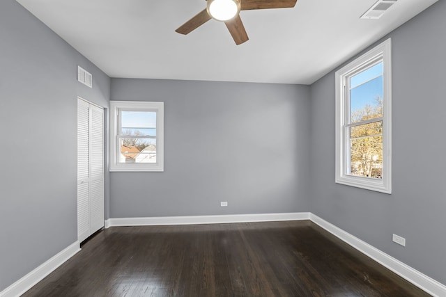 spare room featuring dark hardwood / wood-style floors and ceiling fan