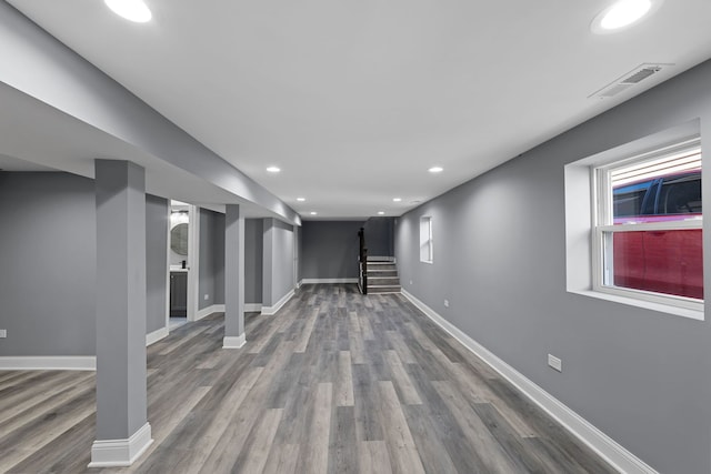 basement featuring a wealth of natural light and hardwood / wood-style floors