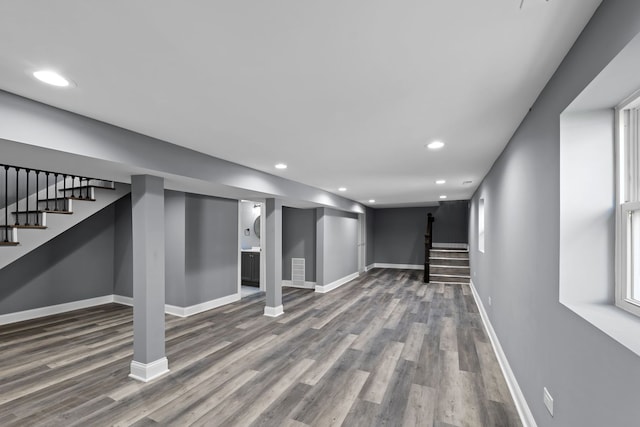 basement with plenty of natural light and wood-type flooring