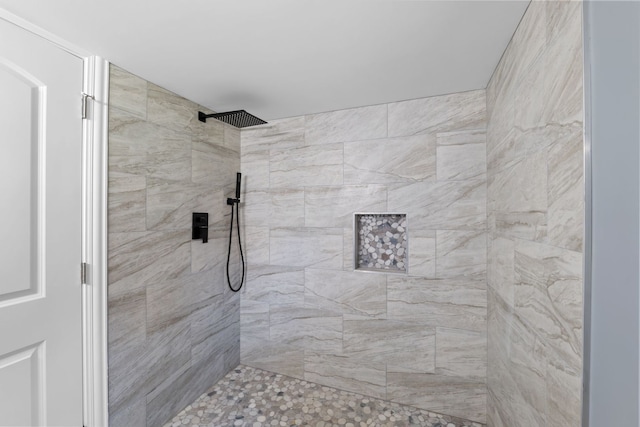 bathroom with tiled shower