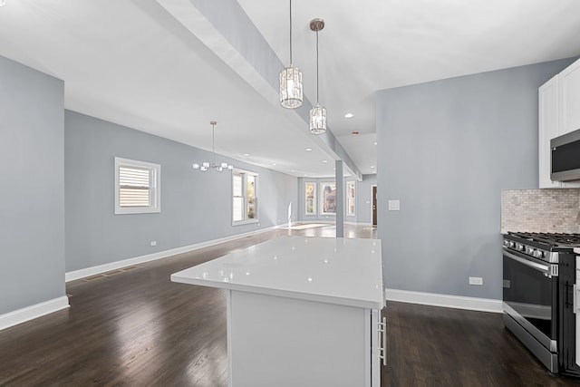 kitchen with stainless steel appliances, white cabinetry, dark hardwood / wood-style floors, a kitchen island, and hanging light fixtures