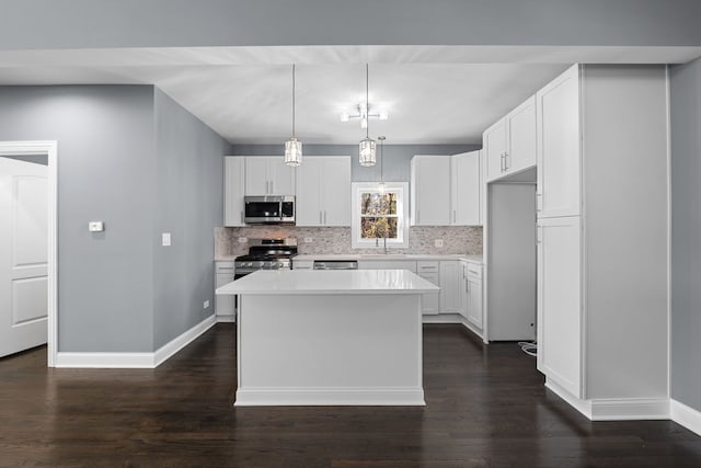 kitchen with white cabinets, appliances with stainless steel finishes, and a center island