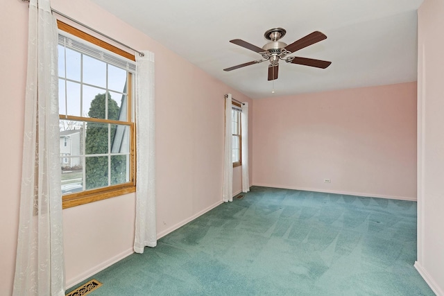 empty room featuring carpet and ceiling fan