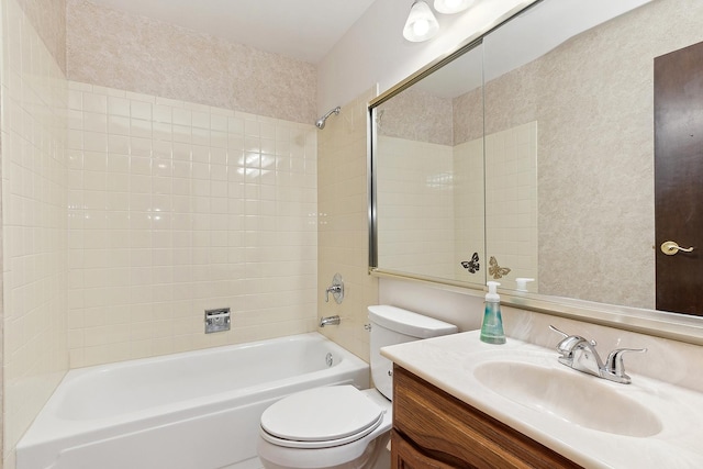 full bathroom with vanity, toilet, and tiled shower / bath combo