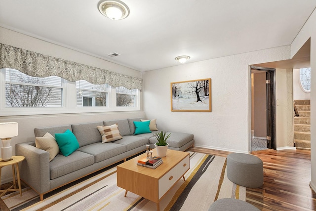 living room with a wealth of natural light and hardwood / wood-style flooring