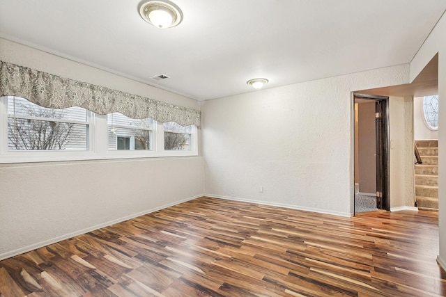 unfurnished room with dark hardwood / wood-style floors