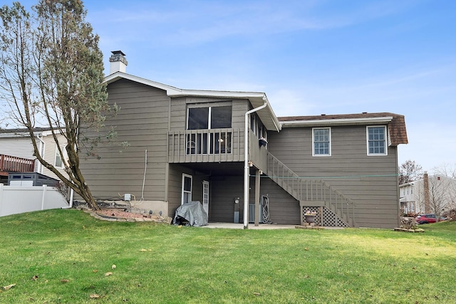 rear view of house with a lawn