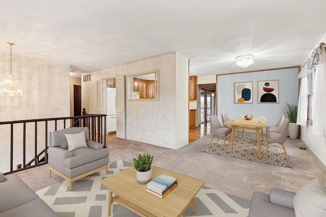 carpeted living room with a chandelier and plenty of natural light