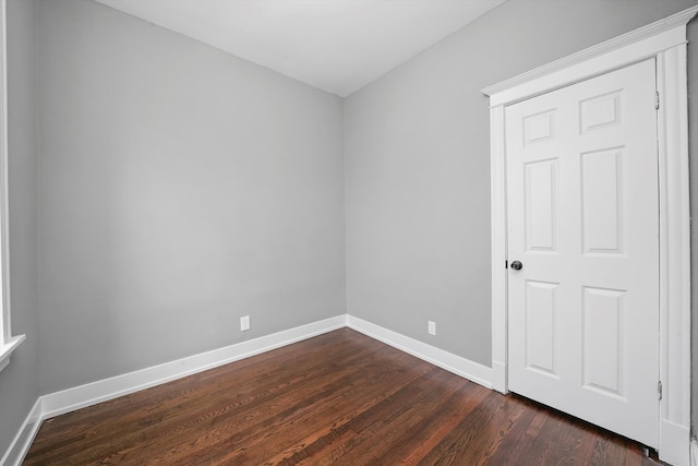 empty room featuring dark hardwood / wood-style flooring