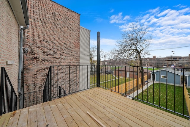 wooden terrace with a lawn