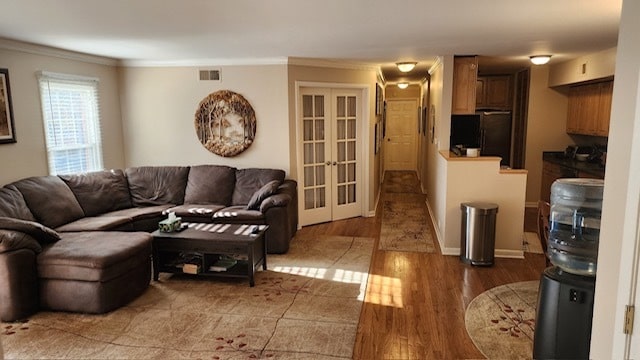 living room with french doors, dark hardwood / wood-style floors, and ornamental molding