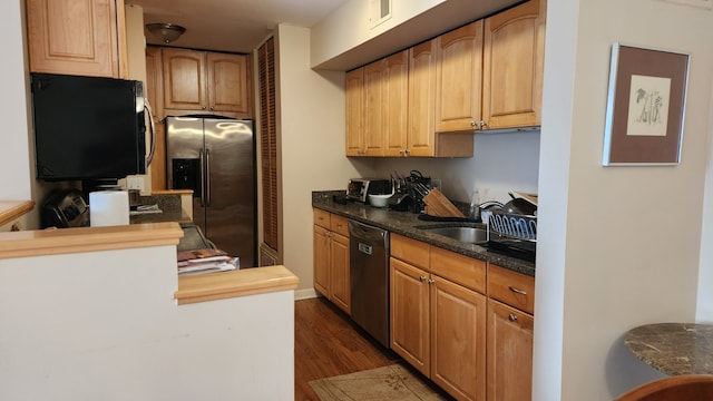 kitchen featuring butcher block countertops, dark hardwood / wood-style floors, sink, and appliances with stainless steel finishes