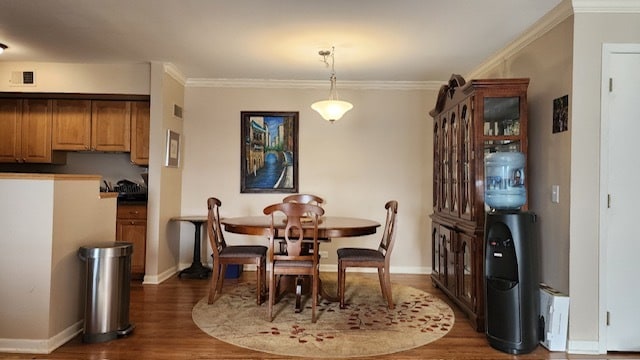 dining room with crown molding and dark wood-type flooring