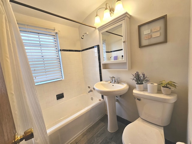 bathroom featuring shower / tub combo, hardwood / wood-style flooring, and toilet