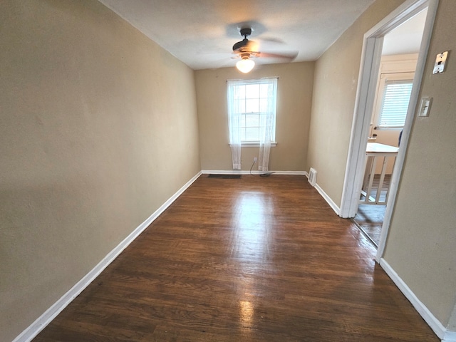 empty room featuring ceiling fan and dark hardwood / wood-style flooring