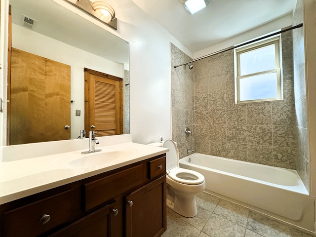 full bathroom with vanity, tiled shower / bath combo, toilet, and tile patterned flooring