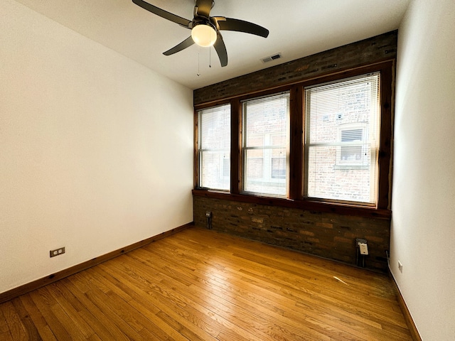 unfurnished room featuring ceiling fan and light wood-type flooring