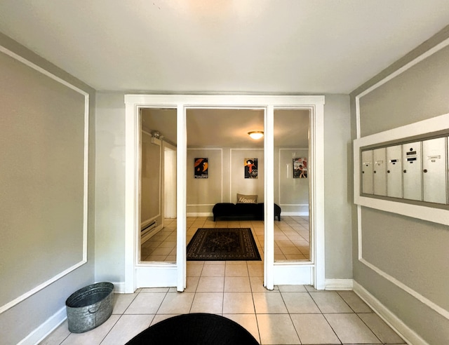 interior space with light tile patterned floors and a mail area